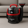 Shampouineuse BISSELL SpotClean Pro posée dans un salon, idéale pour un nettoyage rapide des textiles et tapis.